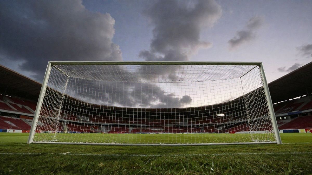 Imagen ilustrativa: una portería de fútbol con la red a contraluz al atardecer, vista desde un ángulo bajo con el cielo de fondo.