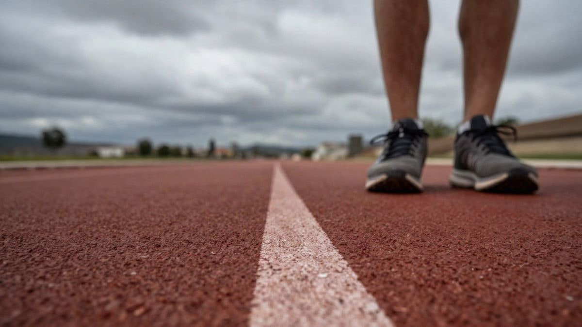 Imagen ilustrativa: pista de atletismo vista a ras de suelo con un cielo nublado de fondo