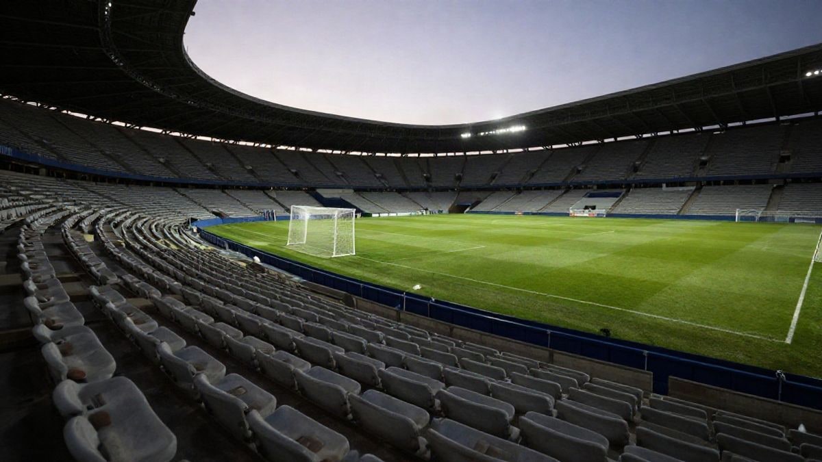Imagen ilustrativa: un estadio de fútbol al atardecer con las gradas vacías y la portería al fondo